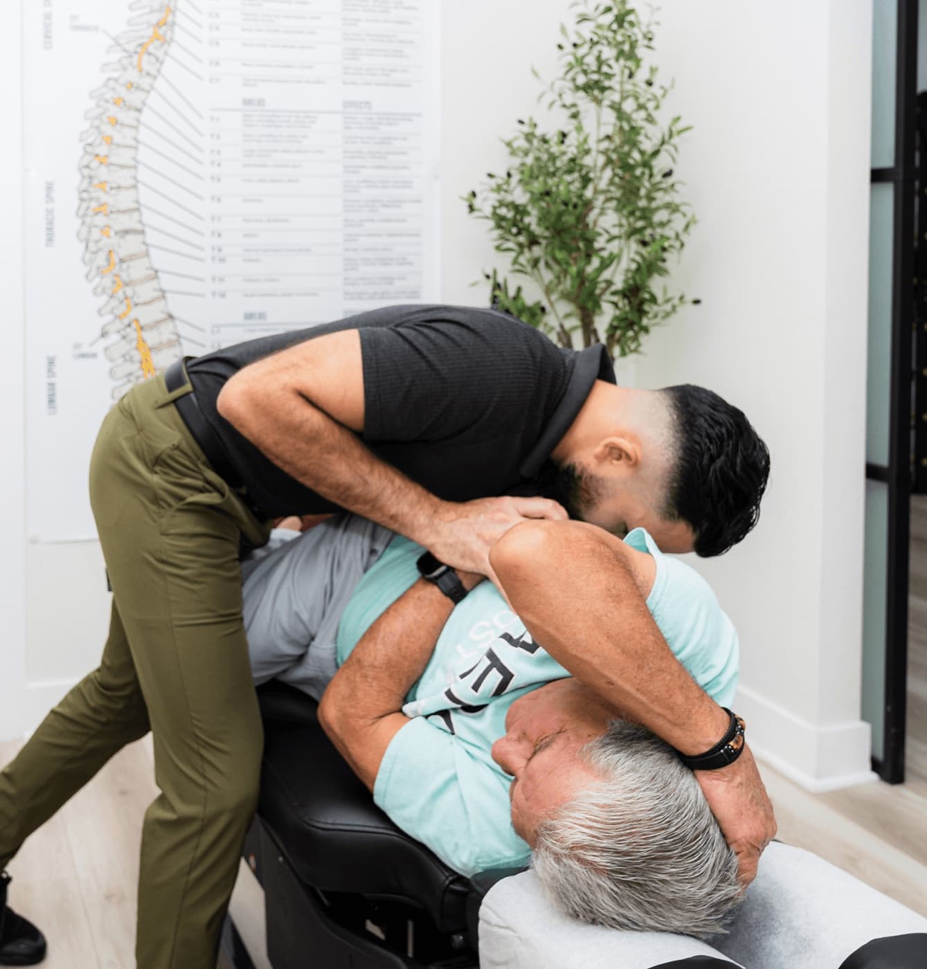 Dr. Denis Chang guiding a patient through a spinal decompression stretch